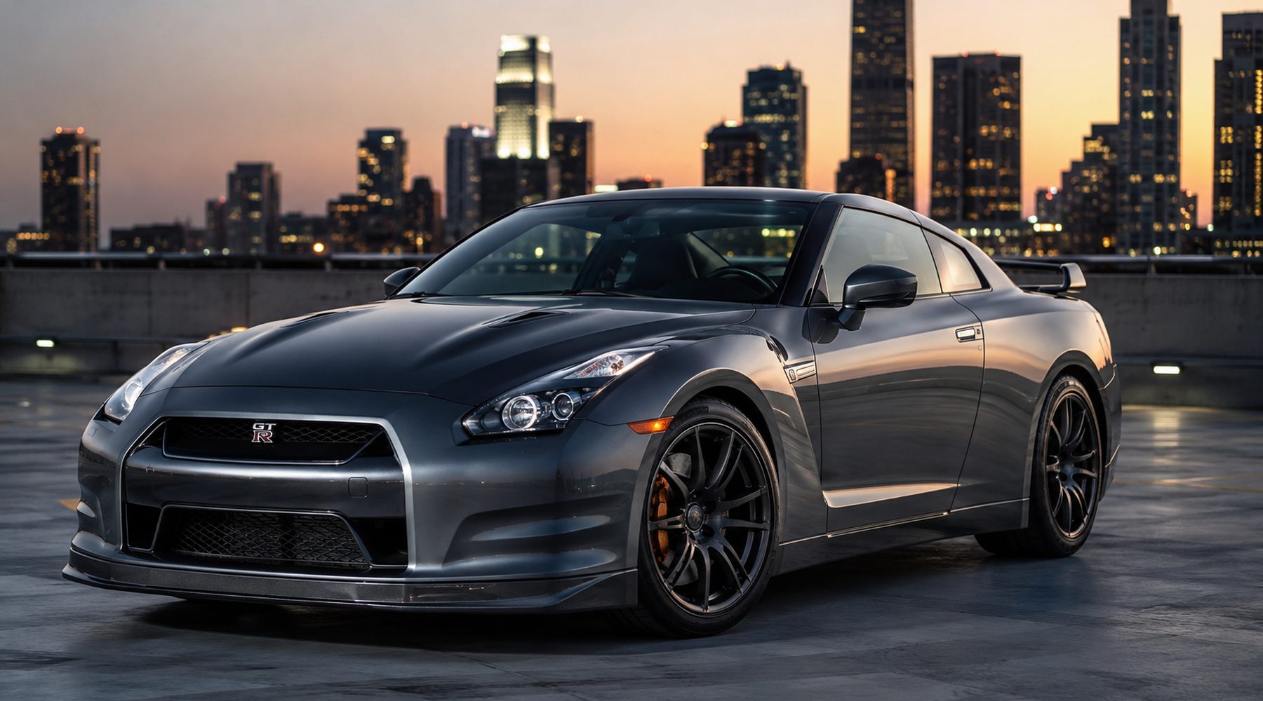 A Nissan GT-R against a city skyline at dusk